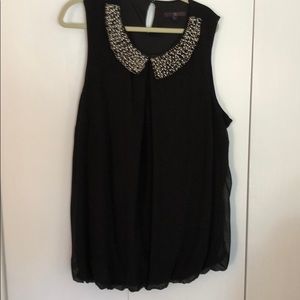 Black sleeveless top w/pearl decorative trim.